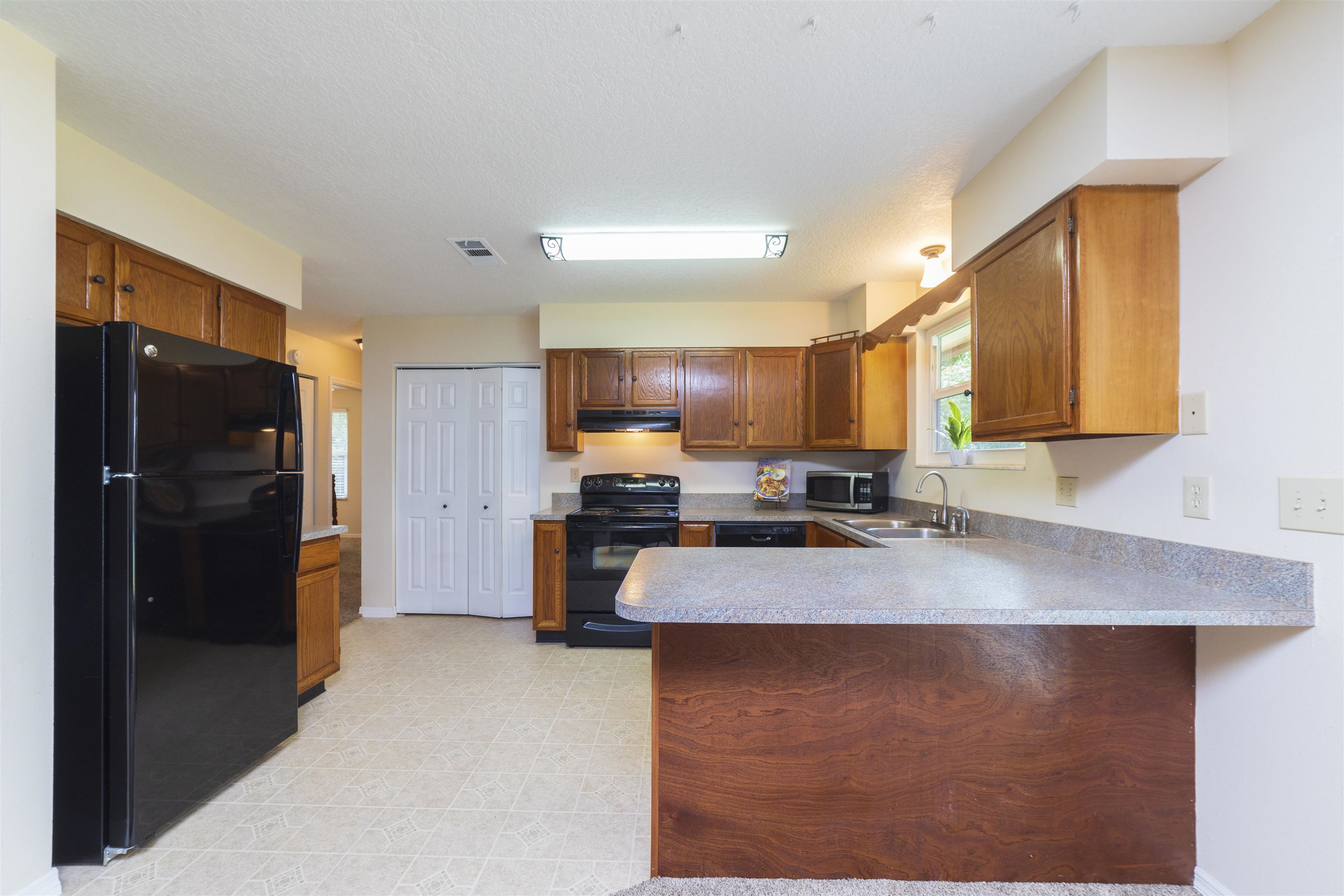 208 Jasmine Road St. Augustine, FL 32086 - Photo 12 of 34 a kitchen with stainless steel appliances granite countertop a refrigerator a stove and a sink