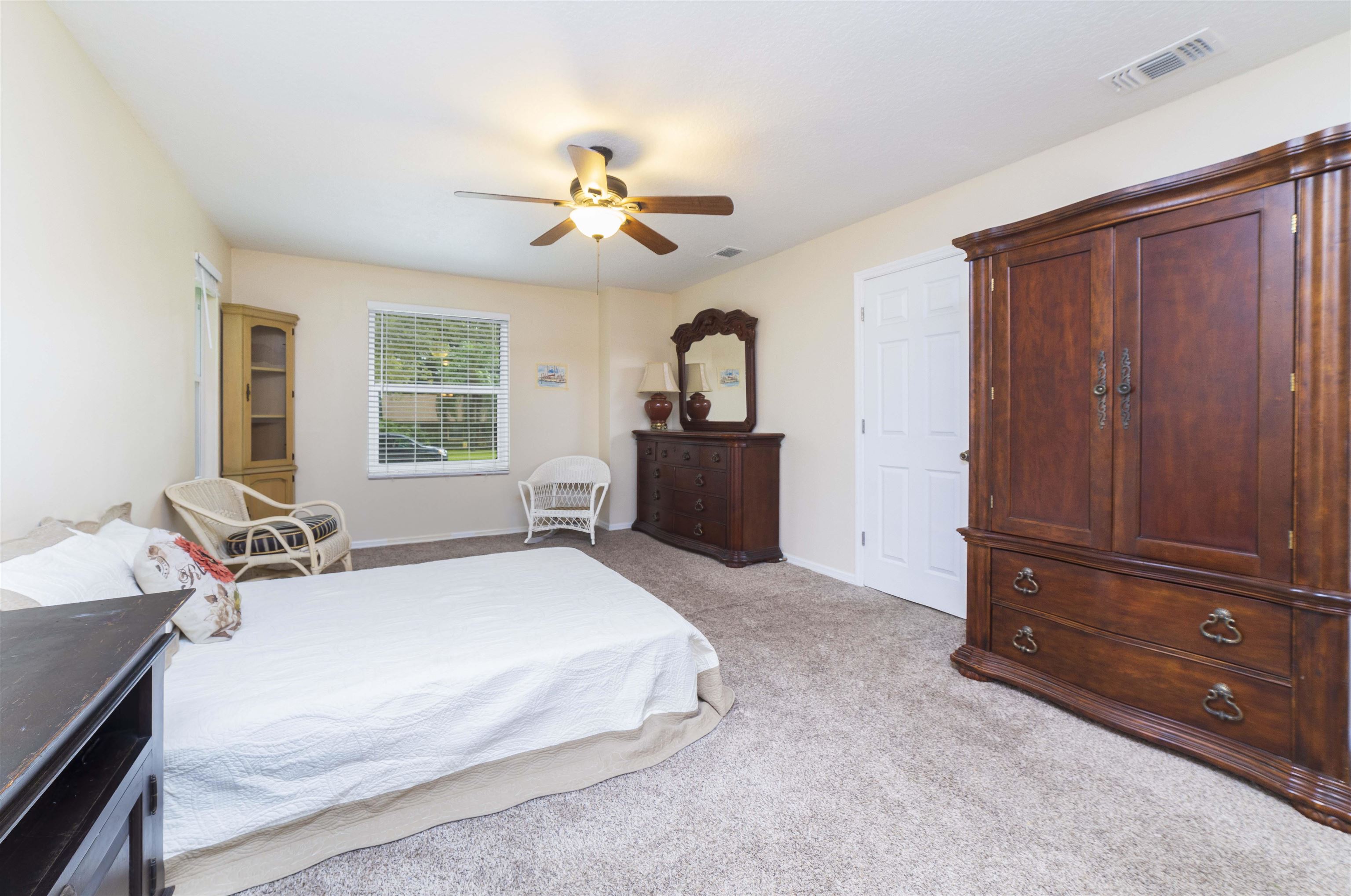 208 Jasmine Road St. Augustine, FL 32086 - Photo 18 of 34 a bedroom with a bed and a dresser