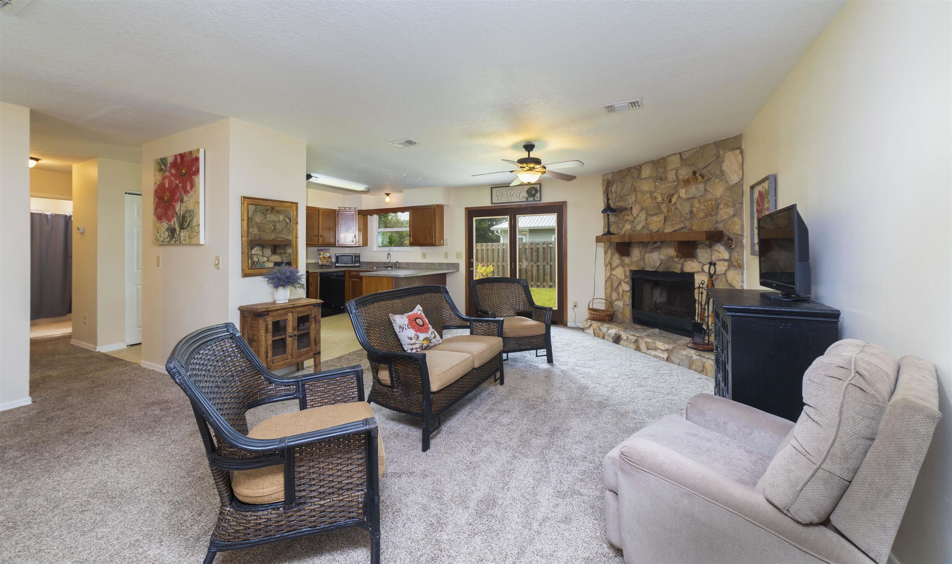 208 Jasmine Road St. Augustine, FL 32086 - Photo 3 of 34 a living room with furniture a fireplace and a flat screen tv