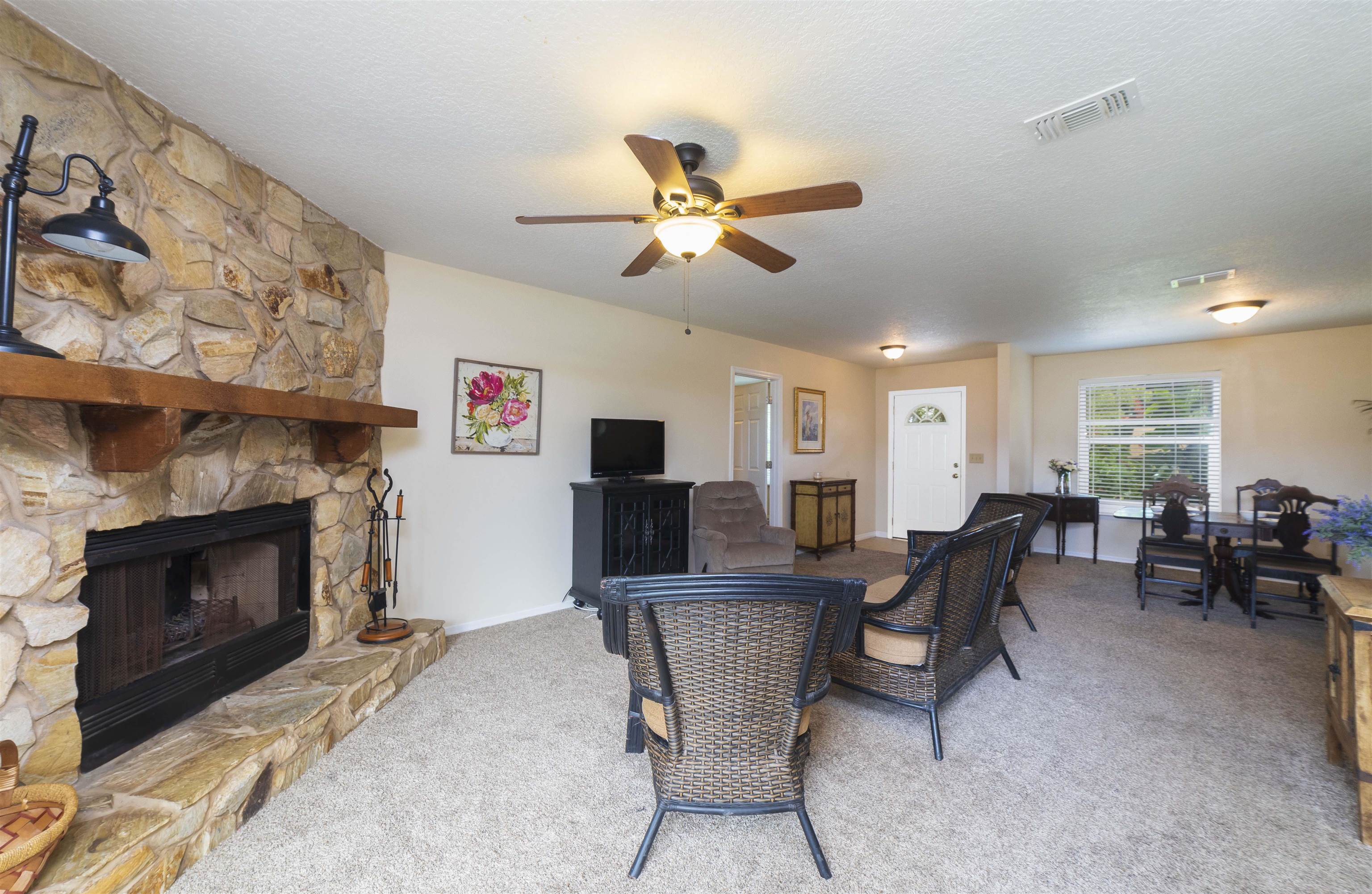 208 Jasmine Road St. Augustine, FL 32086 - Photo 4 of 34 a living room with furniture a fireplace and a flat screen tv