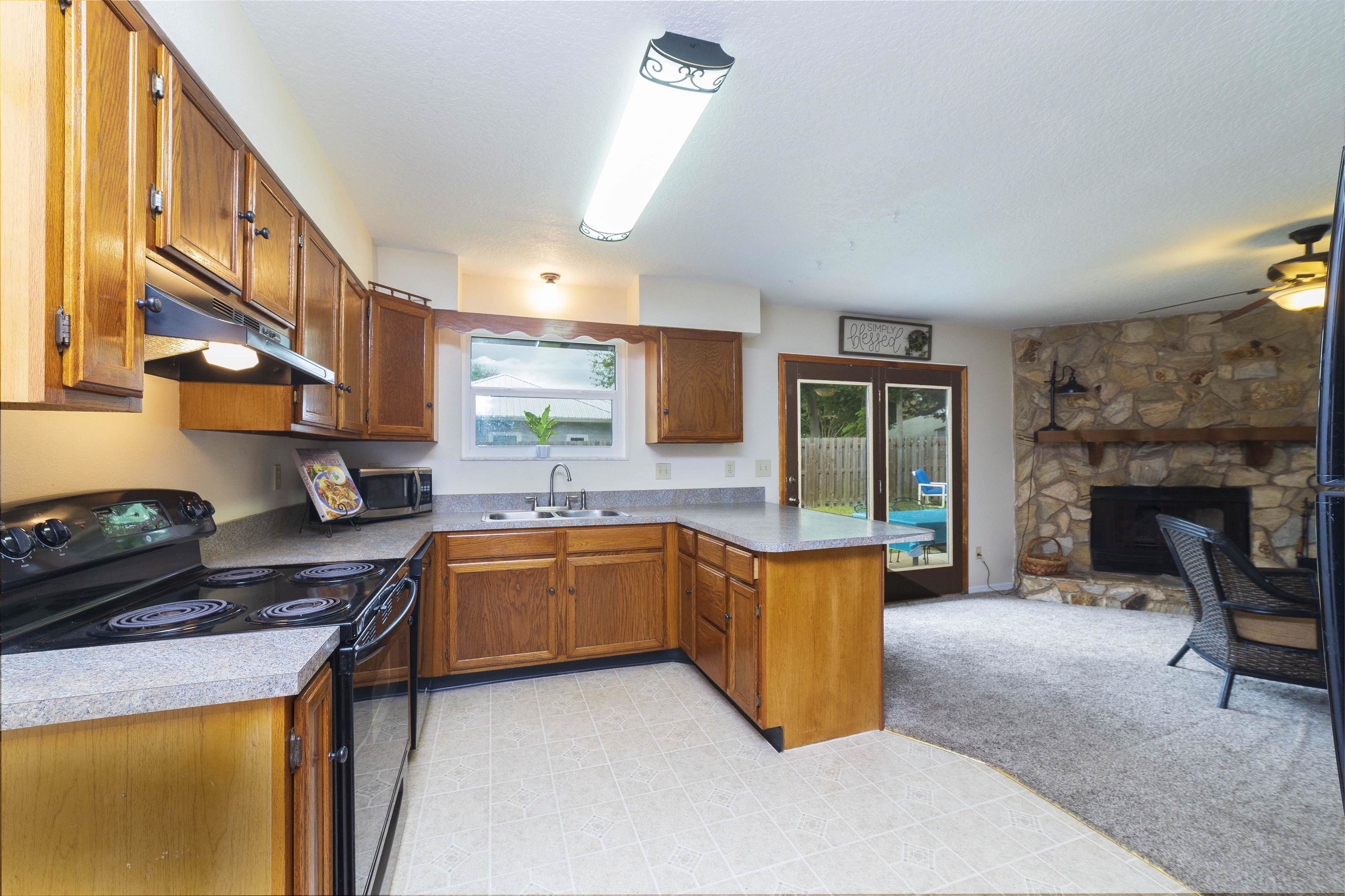 208 Jasmine Road St. Augustine, FL 32086 - Photo 10 of 34 a kitchen with stainless steel appliances granite countertop a stove top oven a sink a counter space and cabinets