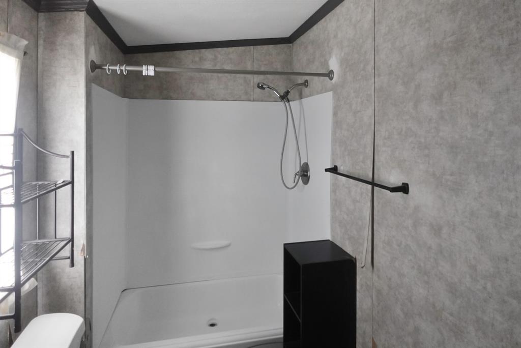 3108 Mistletoe Street Granbury, TX 76048 - Photo 10 of 15 a bathroom that has a shower in it