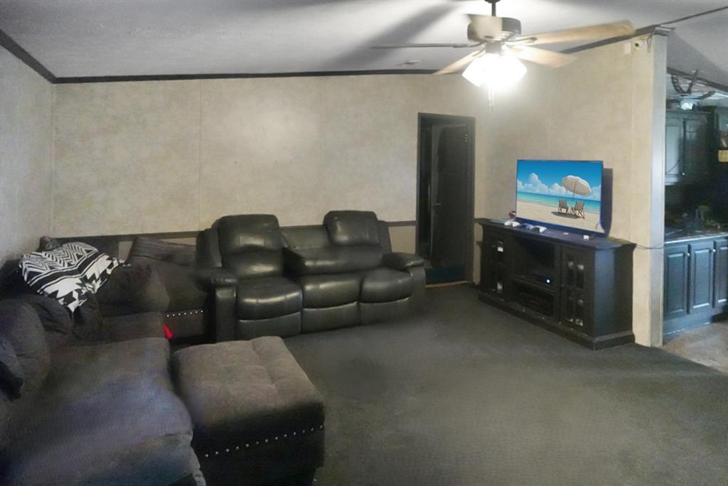 3108 Mistletoe Street Granbury, TX 76048 - Photo 3 of 15 a living room with furniture and a flat screen tv