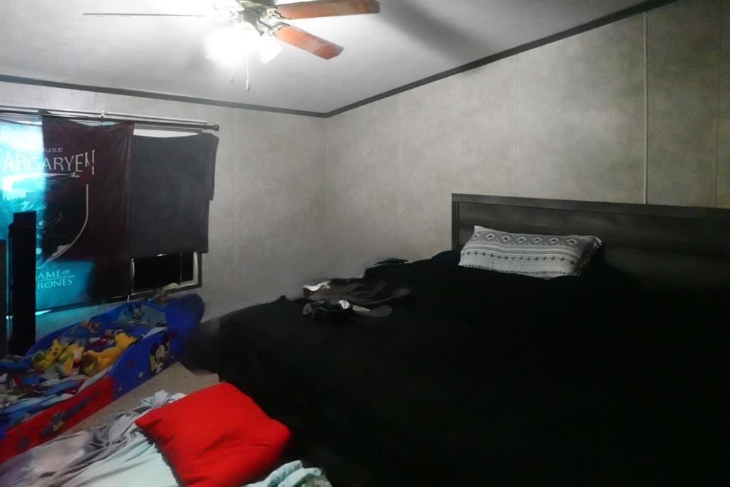 3108 Mistletoe Street Granbury, TX 76048 - Photo 6 of 15 a bed sitting in a room next to a window