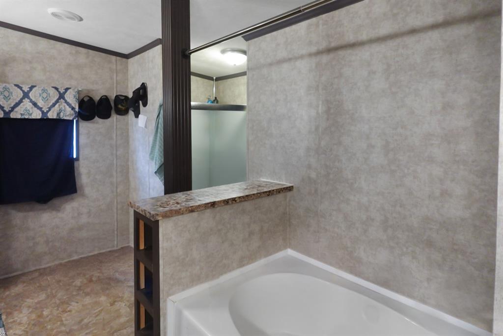 3108 Mistletoe Street Granbury, TX 76048 - Photo 7 of 15 a bathroom with a bathtub and shower