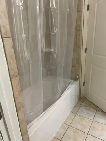 a bath tub sitting next to a shower