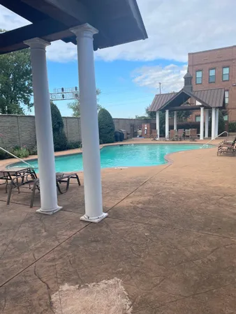 a view of a house with backyard porch and sitting area