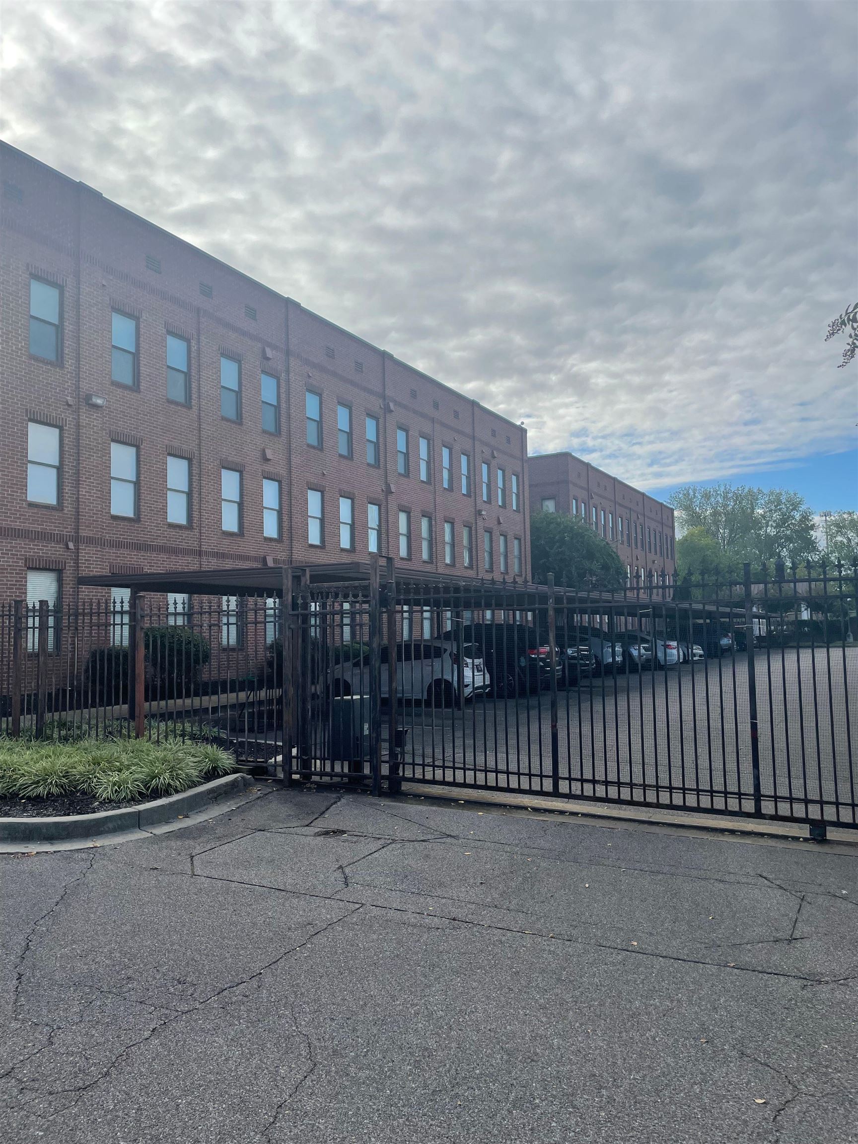 720 Litty Court, Unit 102 Memphis, TN 38103 - Photo 6 of 20 a view of a brick building next to a yard