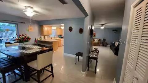 a view of a dining room with furniture and a chandelier