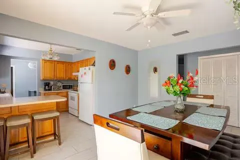 a view of a dining room with furniture and a potted plant