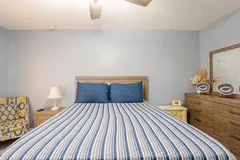 a bedroom with a bed and with furniture