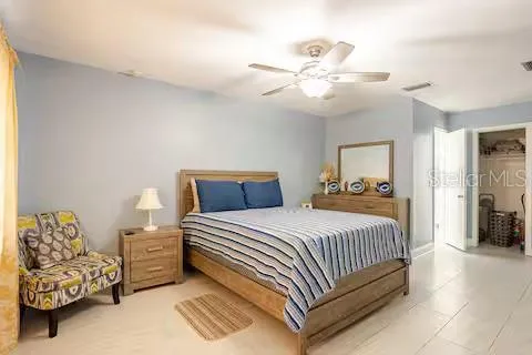 a bedroom with a bed and ceiling fan