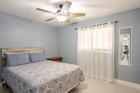 a bedroom with a large bed and a chandelier