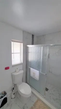 a white toilet sitting next to a bathroom sink