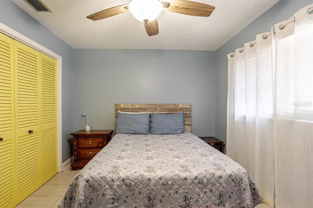 a bedroom with a bed and a window