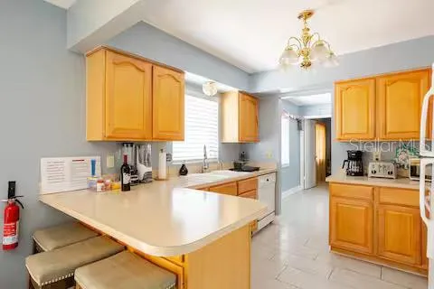 a kitchen with a sink a counter top space cabinets and stainless steel appliances