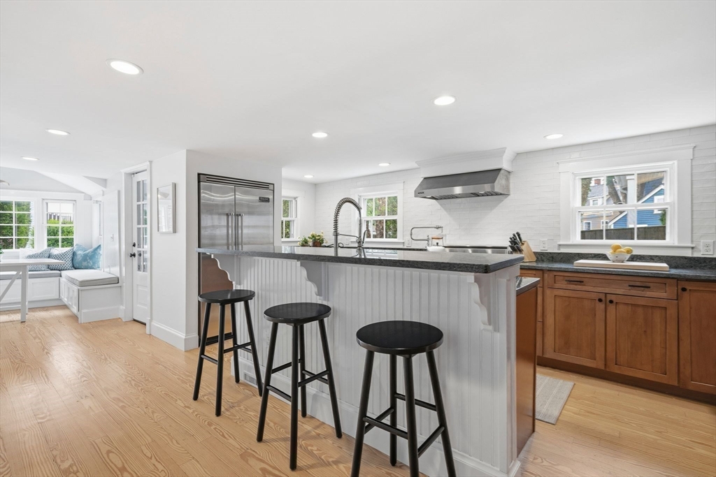 33 Franklin Street Marblehead, MA 01945 - Photo 15 of 42 a kitchen with stainless steel appliances granite countertop a table chairs sink and cabinets