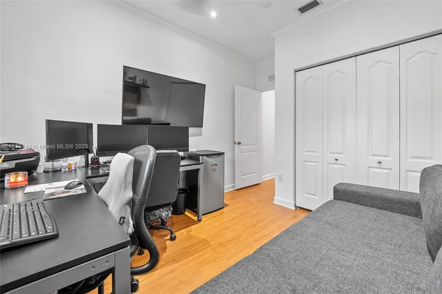 a bedroom with a bed and a desk