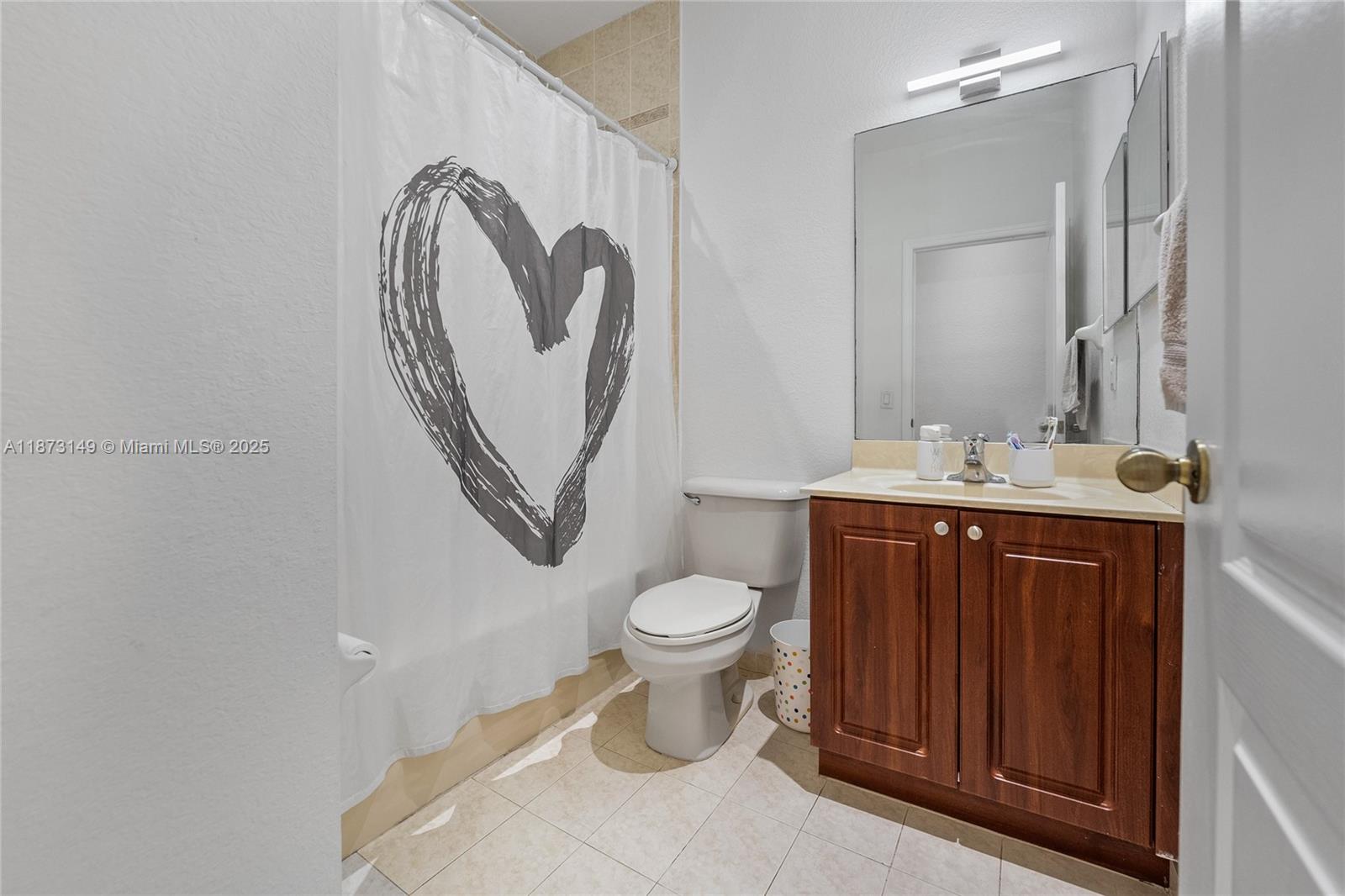 21474 Southwest 85th Path Cutler Bay, FL 33189 - Photo 19 of 30 a bathroom with a toilet sink and mirror