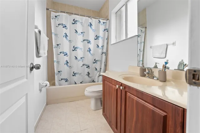 a bedroom with a bed and painting on the wall