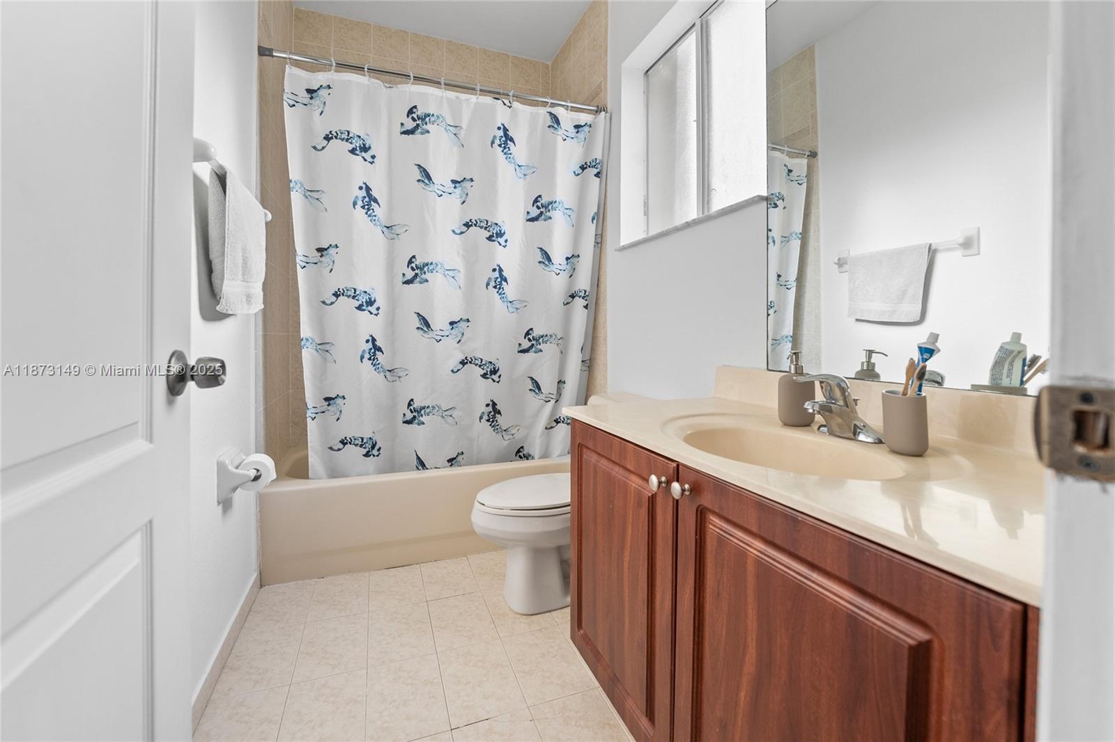 21474 Southwest 85th Path Cutler Bay, FL 33189 - Photo 24 of 30 a bathroom with a granite countertop sink toilet and shower