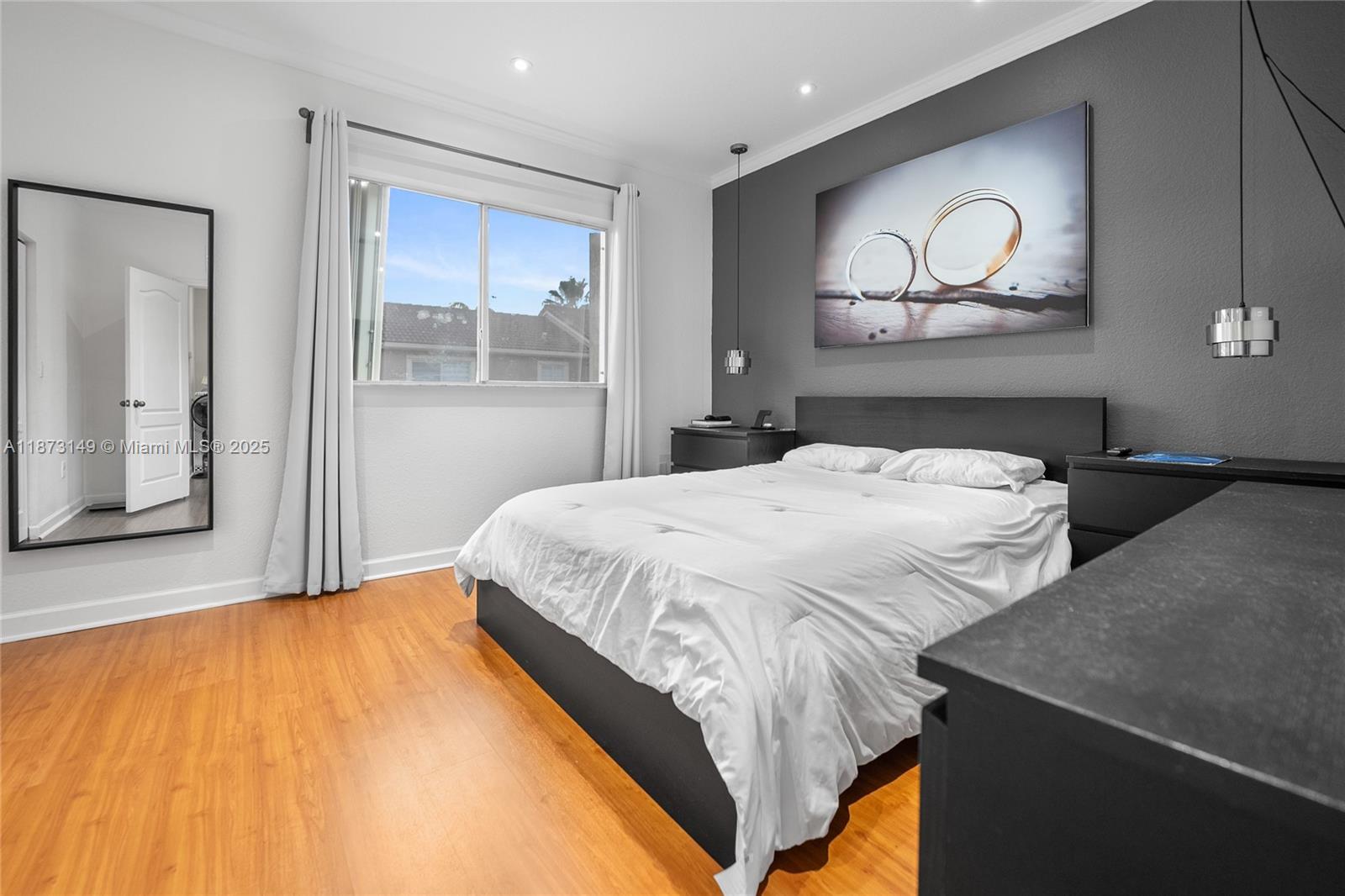 21474 Southwest 85th Path Cutler Bay, FL 33189 - Photo 25 of 30 a bedroom with a bed and painting on the wall