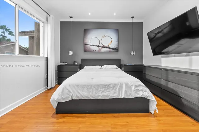 a bedroom with a bed and painting on the wall