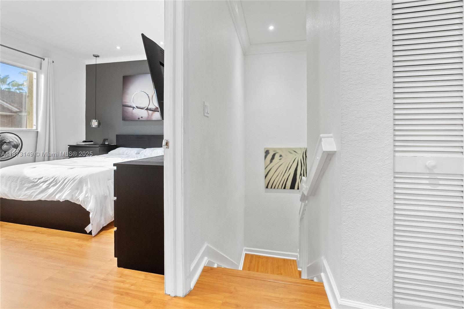 21474 Southwest 85th Path Cutler Bay, FL 33189 - Photo 28 of 30 a bedroom with a bed and painting on the wall