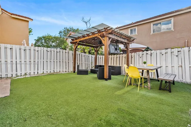 a view of a house with backyard and porch