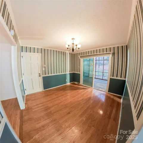 a room with kitchen island a sink a stove a dining table and chairs