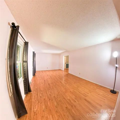an empty room with closet and natural light