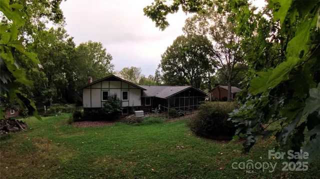 a view of backyard of house with green space