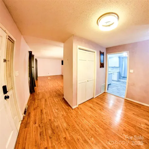 a kitchen with a sink and wooden floor
