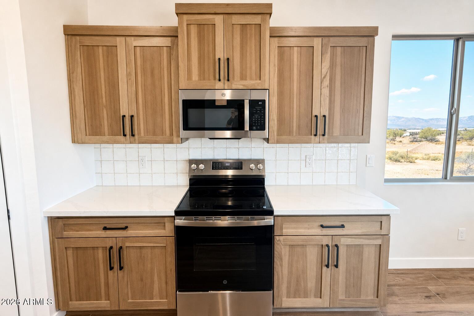 16957 East Bobwhite Way Rio Verde, AZ 85263 - Photo 8 of 25 a kitchen with granite countertop white cabinets and black appliances