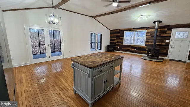 a kitchen with stainless steel appliances granite countertop a stove and a wooden floors