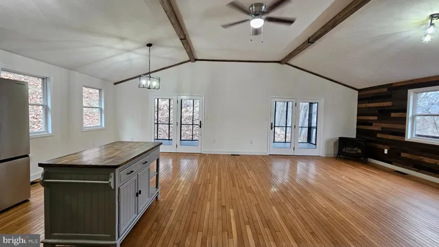 a view of a livingroom with furniture wooden floor and window