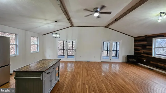 a view of a room with window and wooden floor
