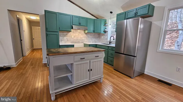 a kitchen with stainless steel appliances a refrigerator and a stove