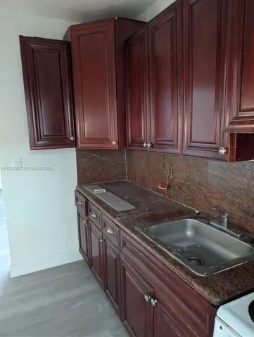 a kitchen with wooden cabinets and a sink