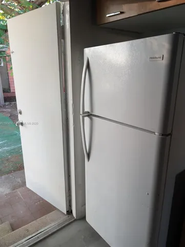 a white refrigerator freezer and a dishwasher sitting inside of a kitchen