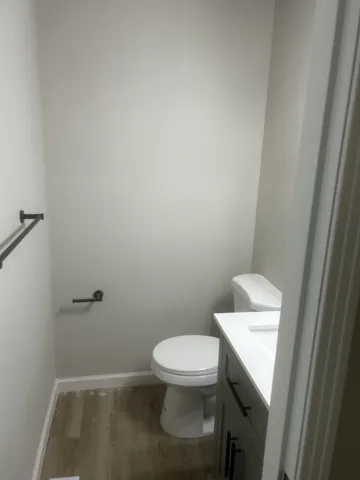 a white toilet sitting next to a sink