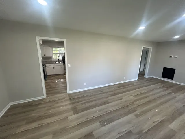 a view of a room with wooden floor and bathroom