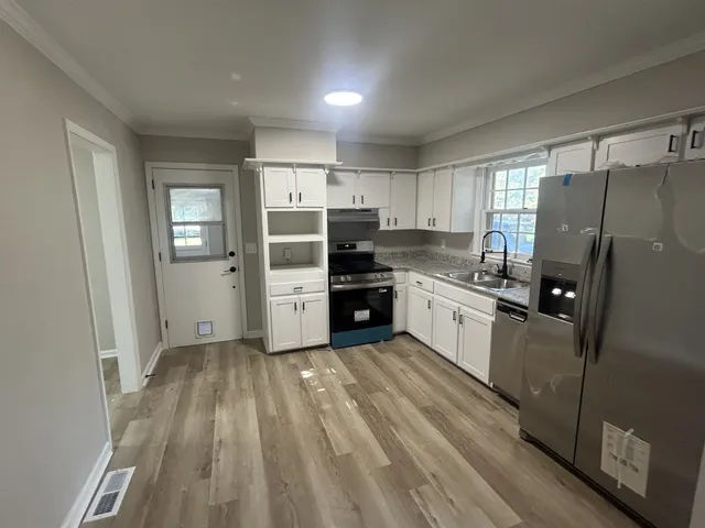 a kitchen with a refrigerator a sink and dishwasher