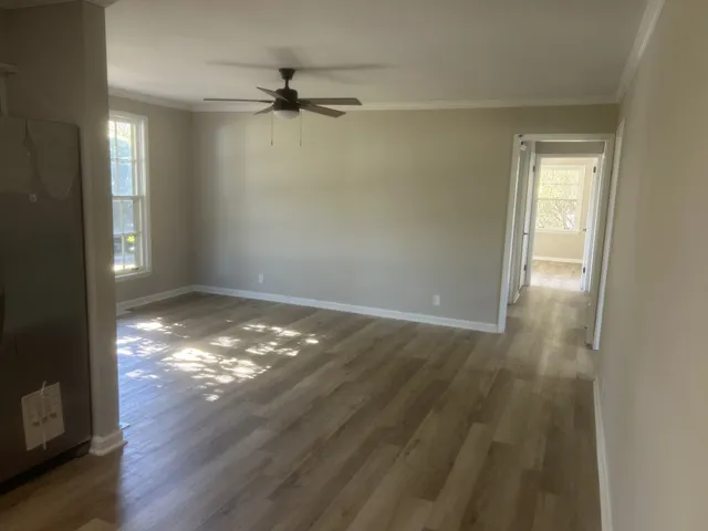a view of a big room with wooden floor closet and windows