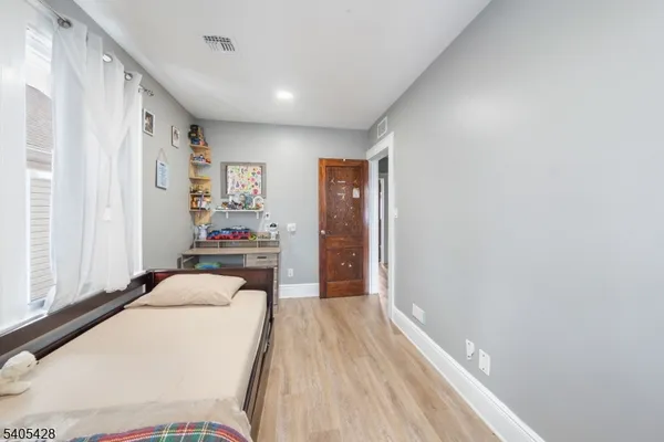 a bedroom with a large bed and a window