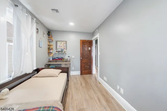 a bedroom with a large bed and a window