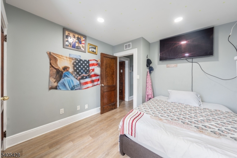 343 Dewitt Street Linden, NJ 07036 - Photo 13 of 33 a bedroom with a bed and a painting on the wall