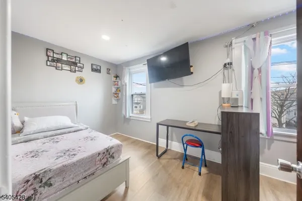 a living room with hard wood floors and a table