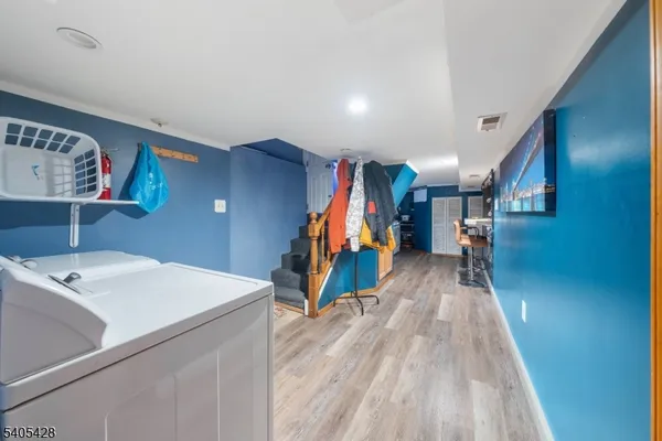 a view of a hallway with wooden floor and stairs