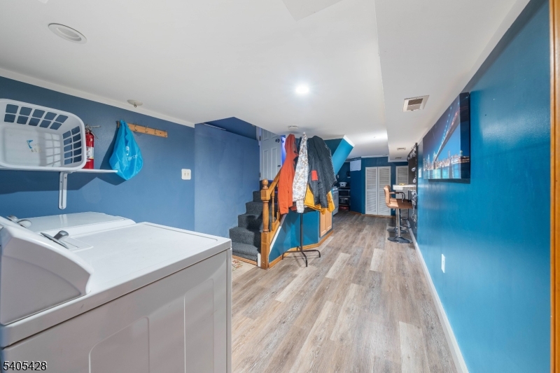 343 Dewitt Street Linden, NJ 07036 - Photo 19 of 33 a view of a hallway with wooden floor and stairs